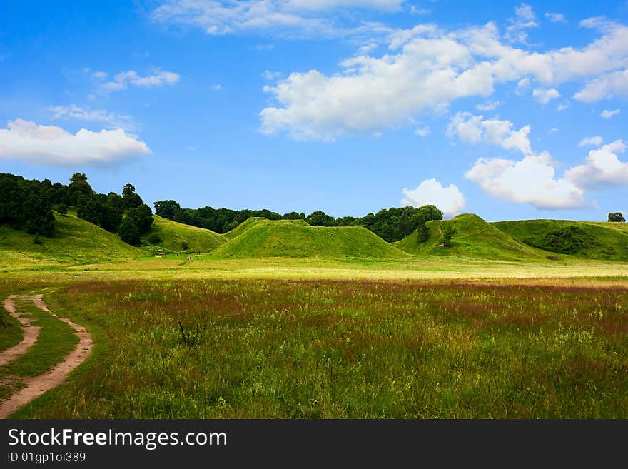 Hills, green grass, blue sky, spring