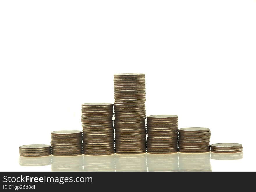 Stacks coins isolated on a white. Close up. Stacks coins isolated on a white. Close up