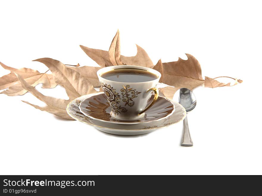 Cup of cofe on the white background with leaves. Cup of cofe on the white background with leaves