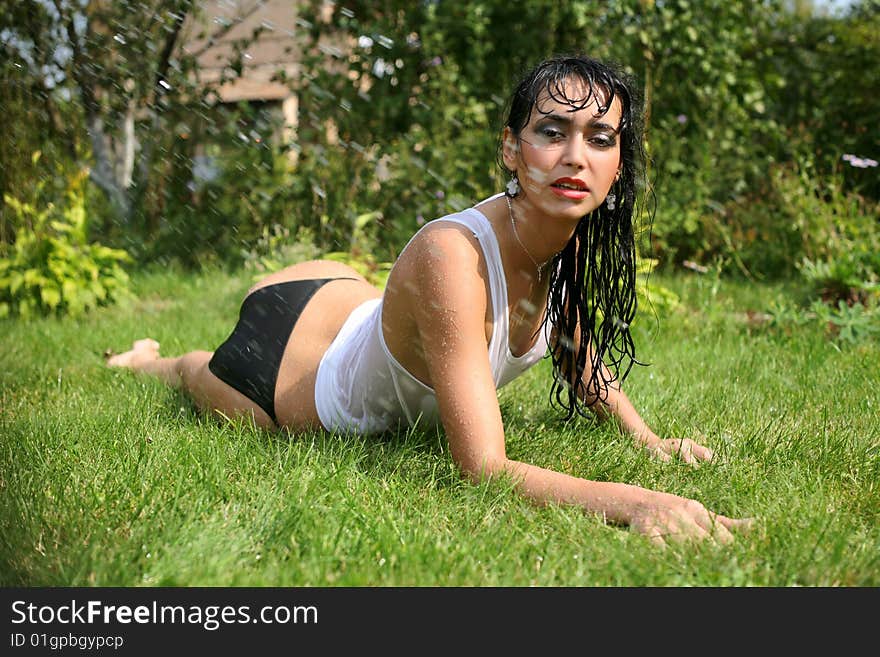 Lovely girl under rain in summertime