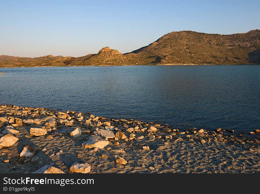 Lake and mountains landscape with blue sky