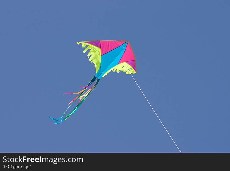 Colored kite in blue sky. Colored kite in blue sky