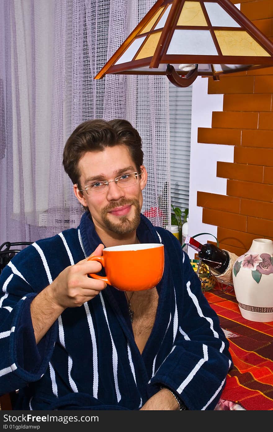 Young man in his kitchen having breakfast