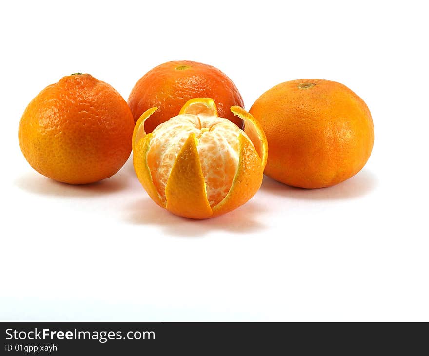 Four orange tangerines isolated on a white background