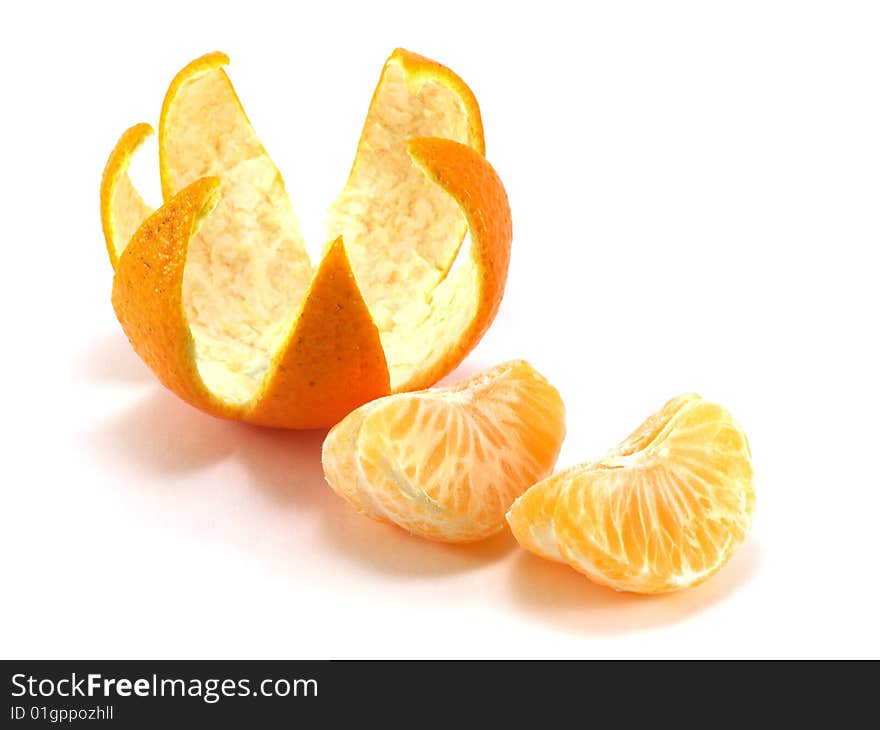 Tangerine peel cut out in the form of a crown and a tangerine segments isolated on a white background