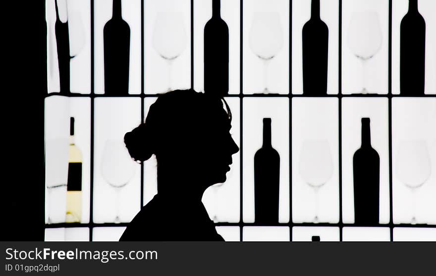 Silouette Of A Waitress Against Bottle And Glasses