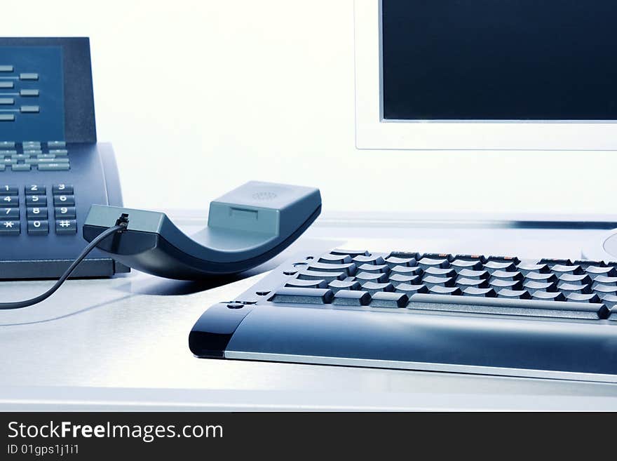 Business concept - keyboard, PC monitor, telephone - high key