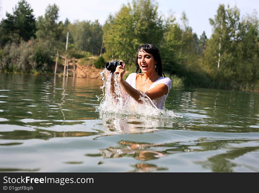 Lovely girl photographer in water