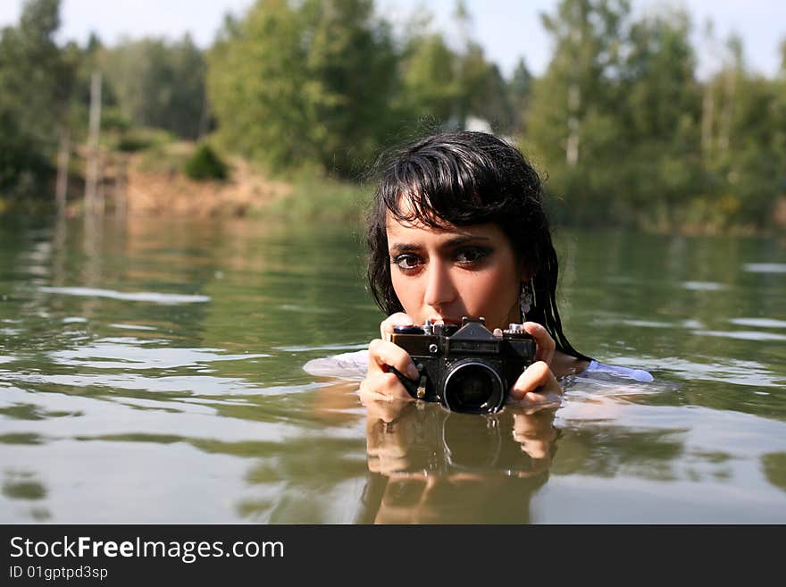 Lovely girl photographer in water