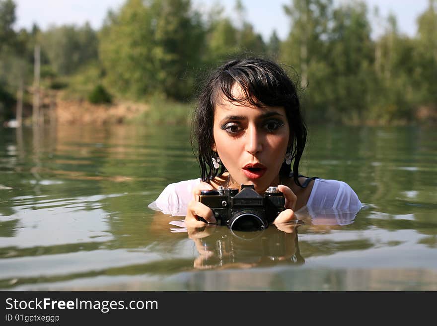 Lovely girl photographer in water