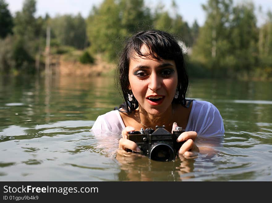 Lovely girl photographer in water