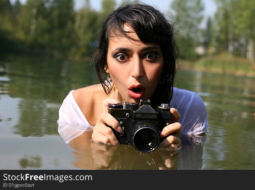 Lovely girl photographer in water