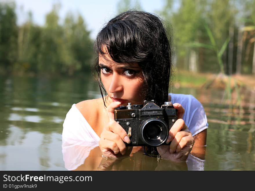 Photographer in water with camera