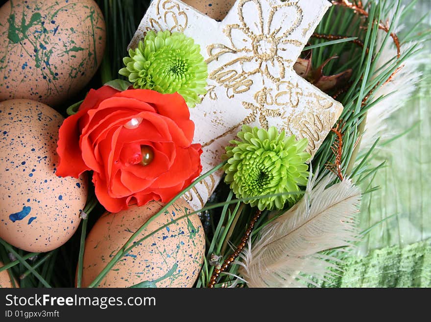 Decorated eggs in a wreath on a green background. Decorated eggs in a wreath on a green background