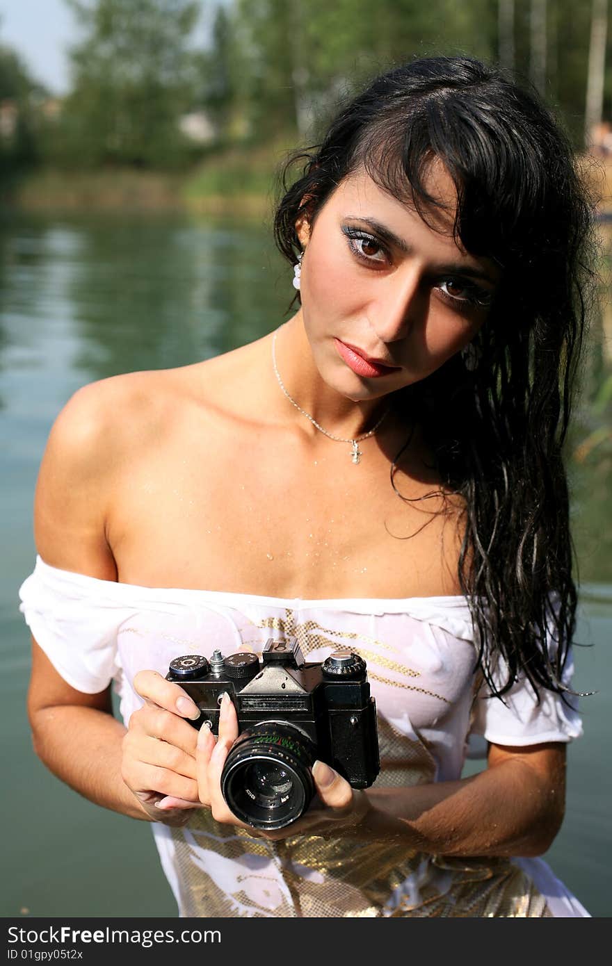 Lovely girl photographer in water