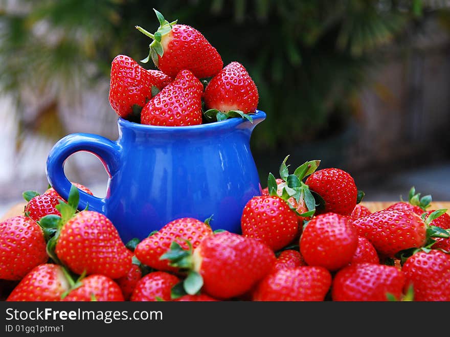 Strawberry in a blue cup buckets