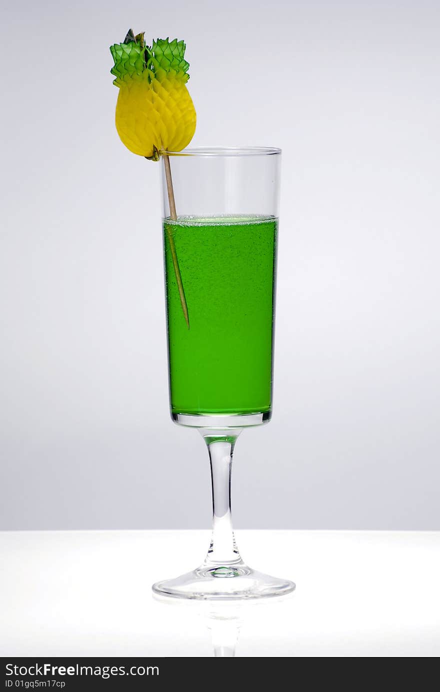 Green cocktail glass on a clean white background