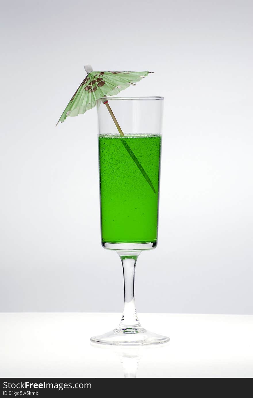 Green cocktail glass on a clean white background