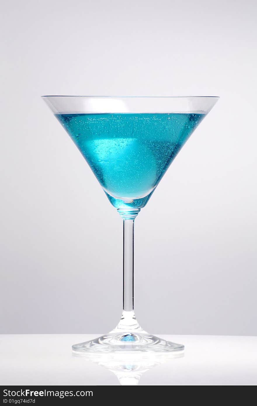 Blue cocktail glass on a clean white background