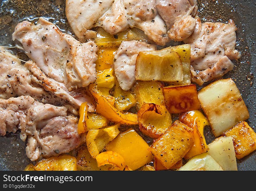 Chicken meat frying with yellow peppers. Chicken meat frying with yellow peppers