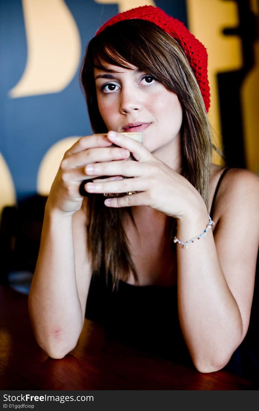 A beautiful young woman having lucnh in a cafe