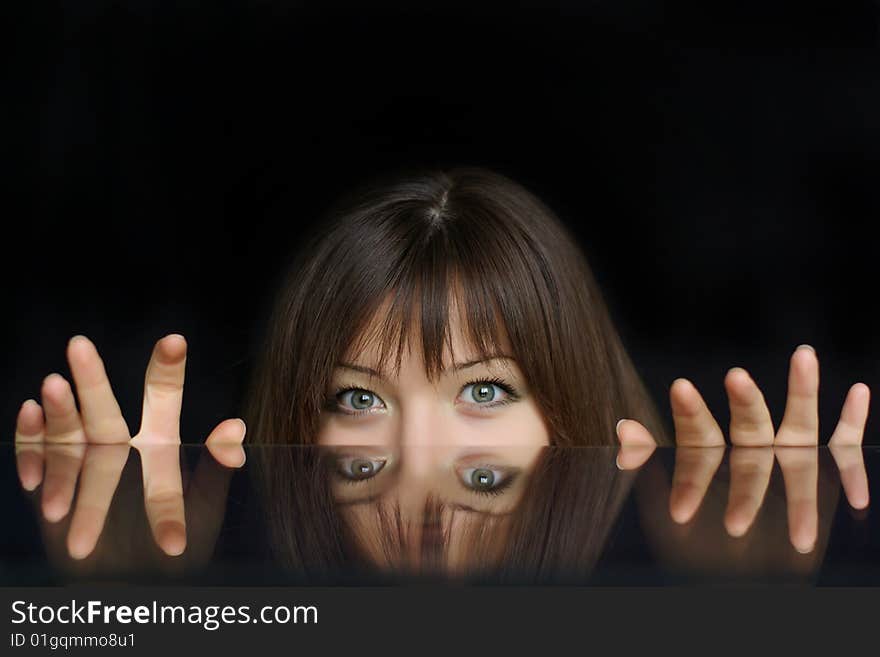 Face and fingers reflection in glass on black background. Face and fingers reflection in glass on black background.