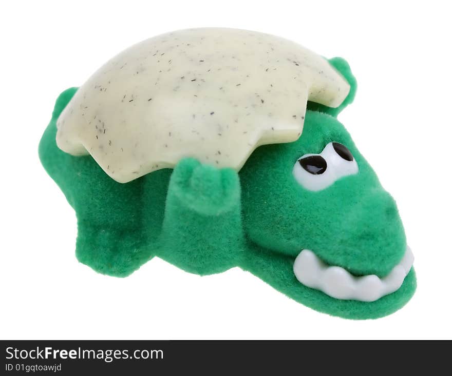 Funny green crocodile toy with shell on white background. Funny green crocodile toy with shell on white background