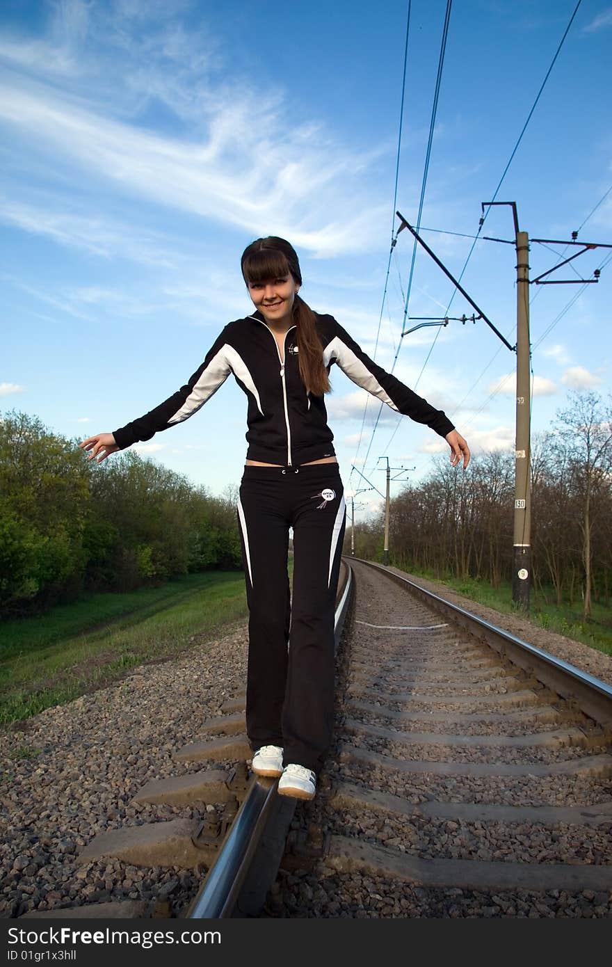 Woman take a walk on railway. Balanced. Woman take a walk on railway. Balanced