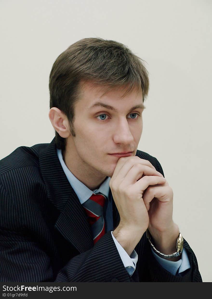 Portrait of a young thoughtful businessman dressed in a business suit and shirt. Portrait of a young thoughtful businessman dressed in a business suit and shirt