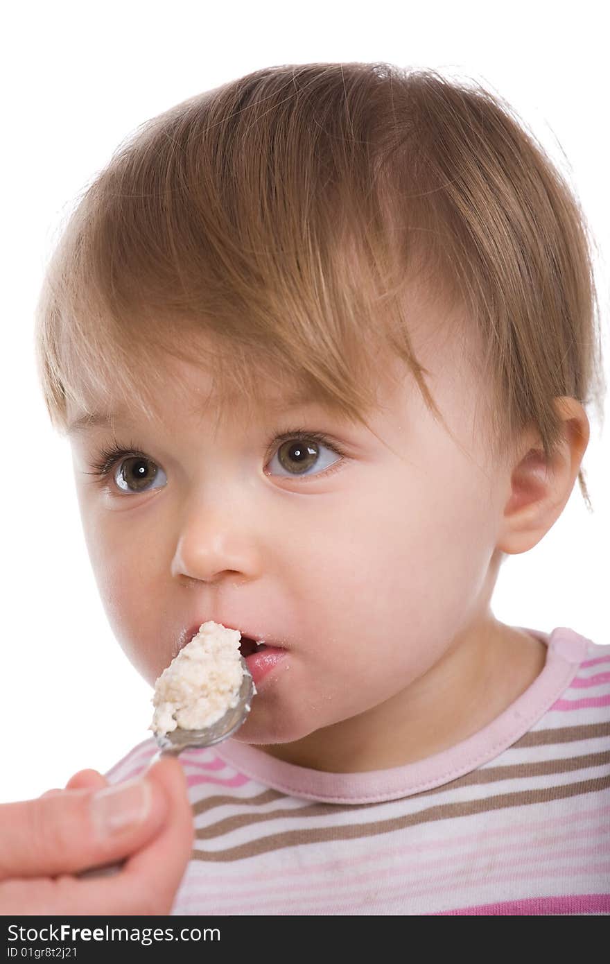 Happy baby girl eating isolated