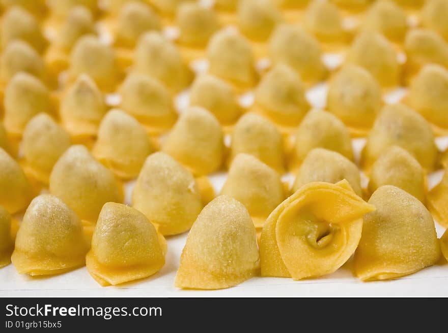 Closeup of italian tortellini on white background