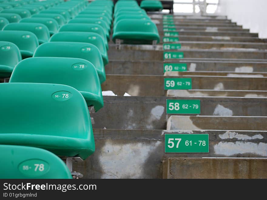 Numbering and aisle of stadium seats with row numbers and seat numbers.