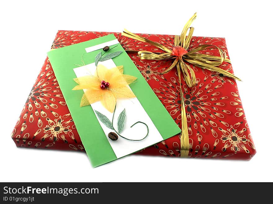 Red gift-box with a gold bow and a card