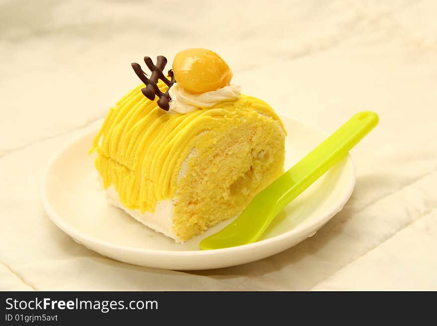 Sliced cake in dish with a spoon,white background . Sliced cake in dish with a spoon,white background