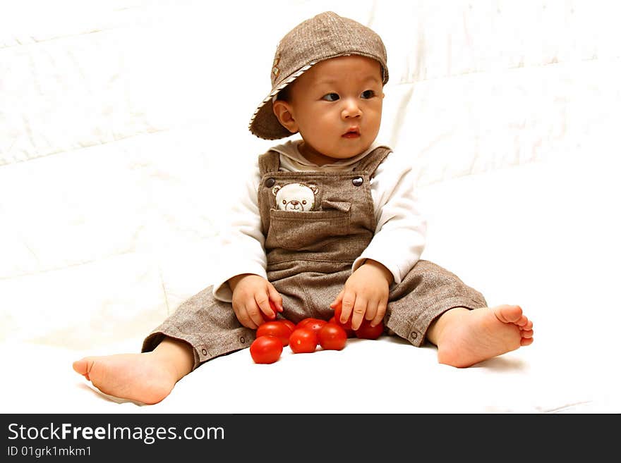 Cute Asia child with Tomato,bare feet. Cute Asia child with Tomato,bare feet