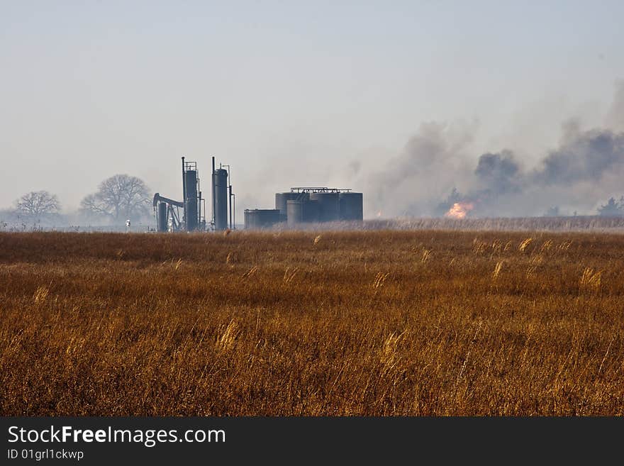 Grass fire near a some oil storage tanks and pump jack