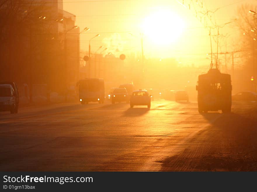 Street lighted up by the rays of a sunset sun. Street lighted up by the rays of a sunset sun