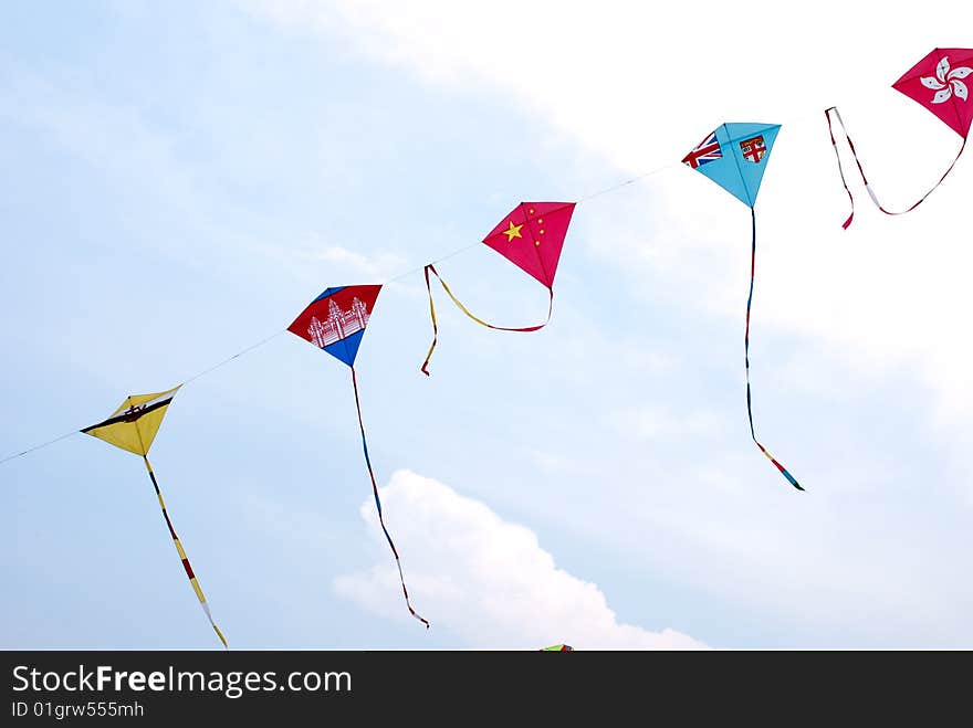 Waving asian countries national flag kites in action