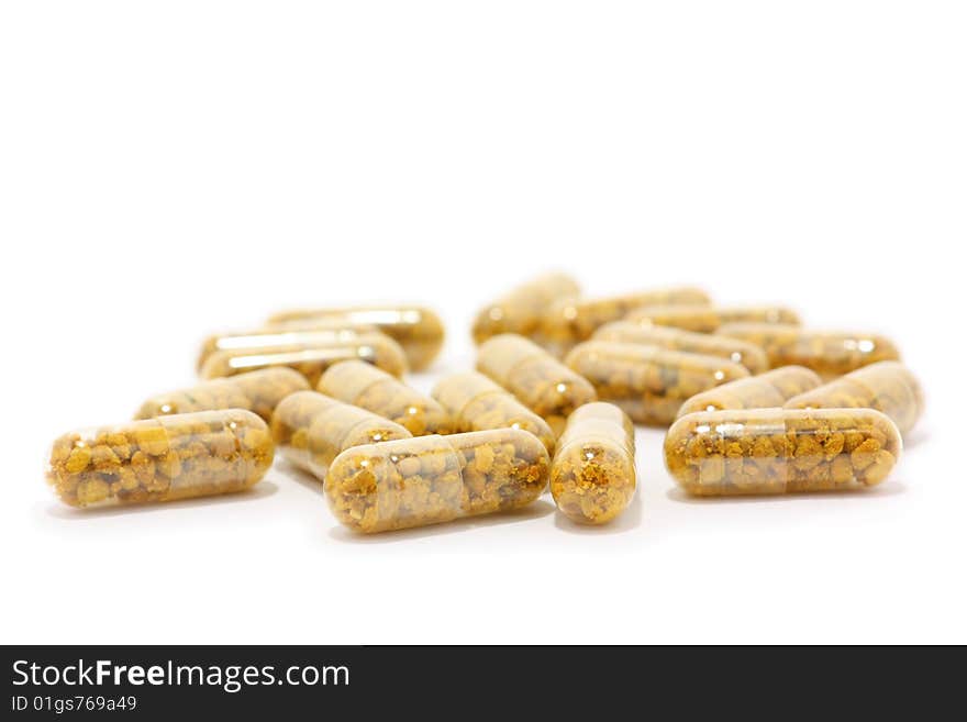 Orange pills on the white background