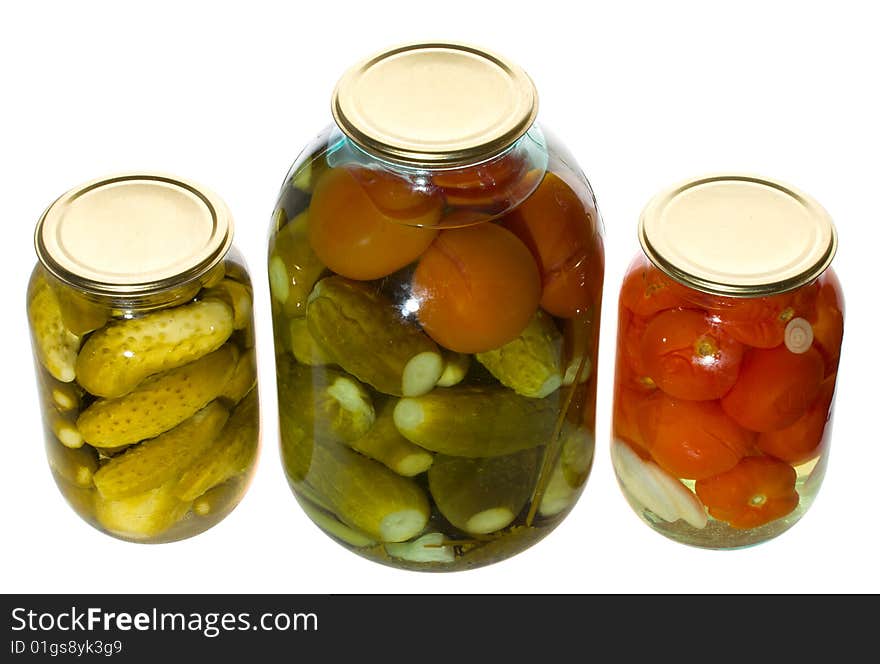 One big and two small jars with vegetables, isolated on white