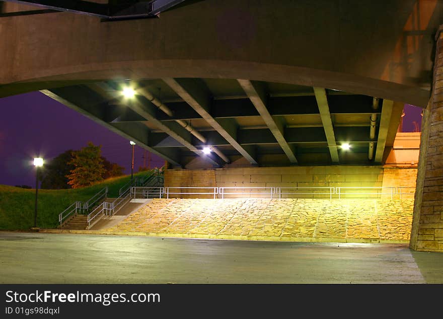 Concrete support underneath a bridge at night. Concrete support underneath a bridge at night.