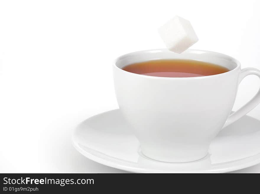 Cup of tea with sugar cube