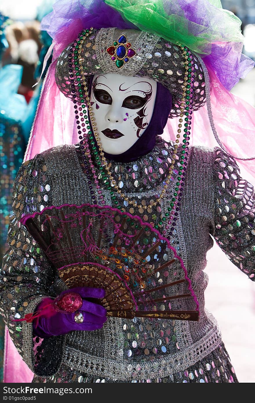 Silver costume with colourful sequins at the Venice Carnival. Silver costume with colourful sequins at the Venice Carnival