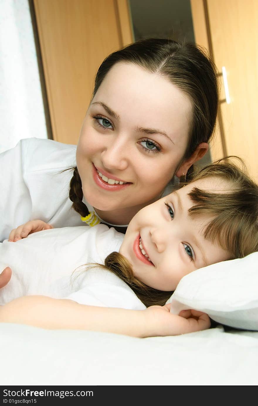 Mother and daughter in bed