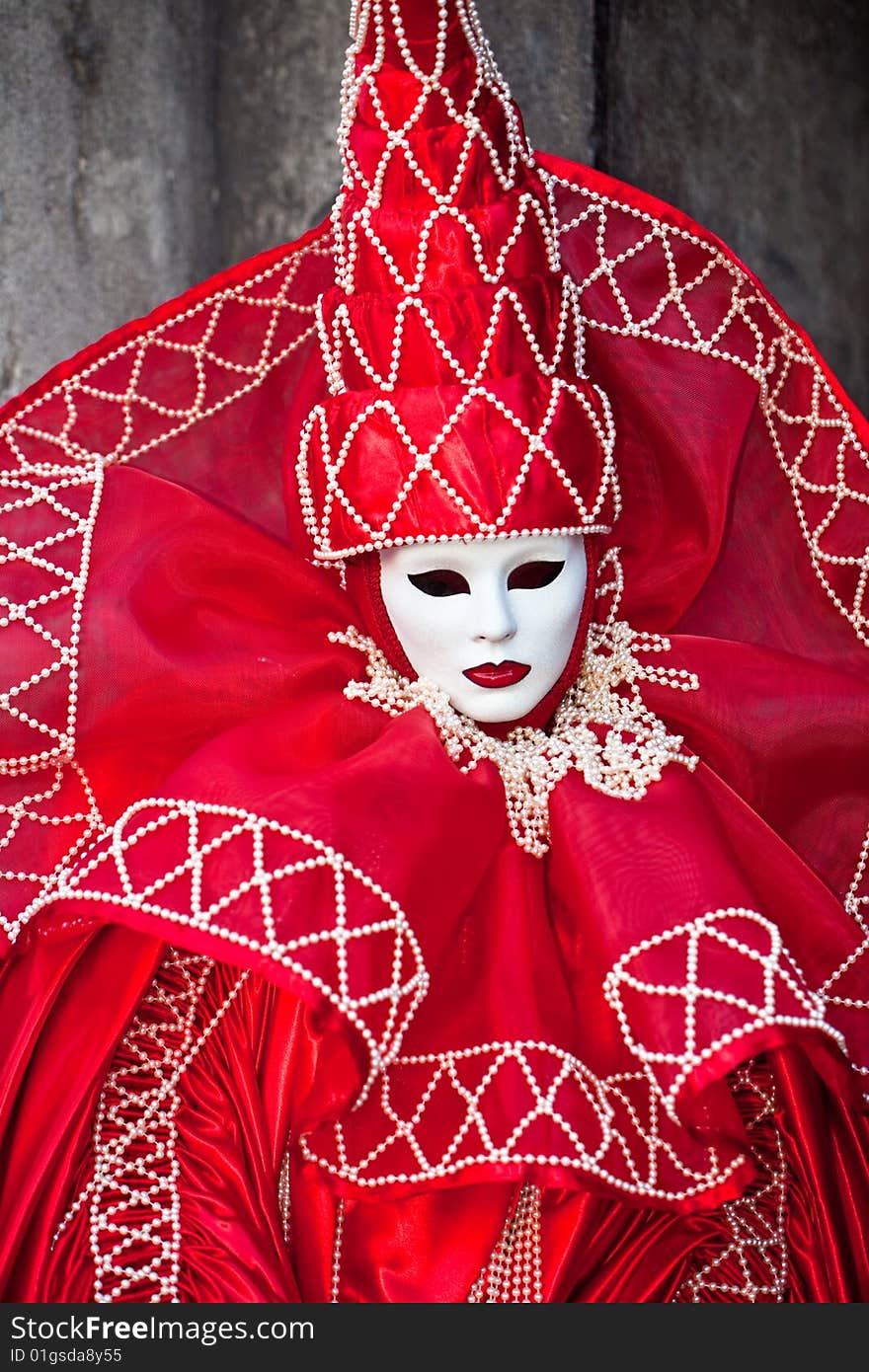 Red costume with white pearls at the Venice Carnival. Red costume with white pearls at the Venice Carnival