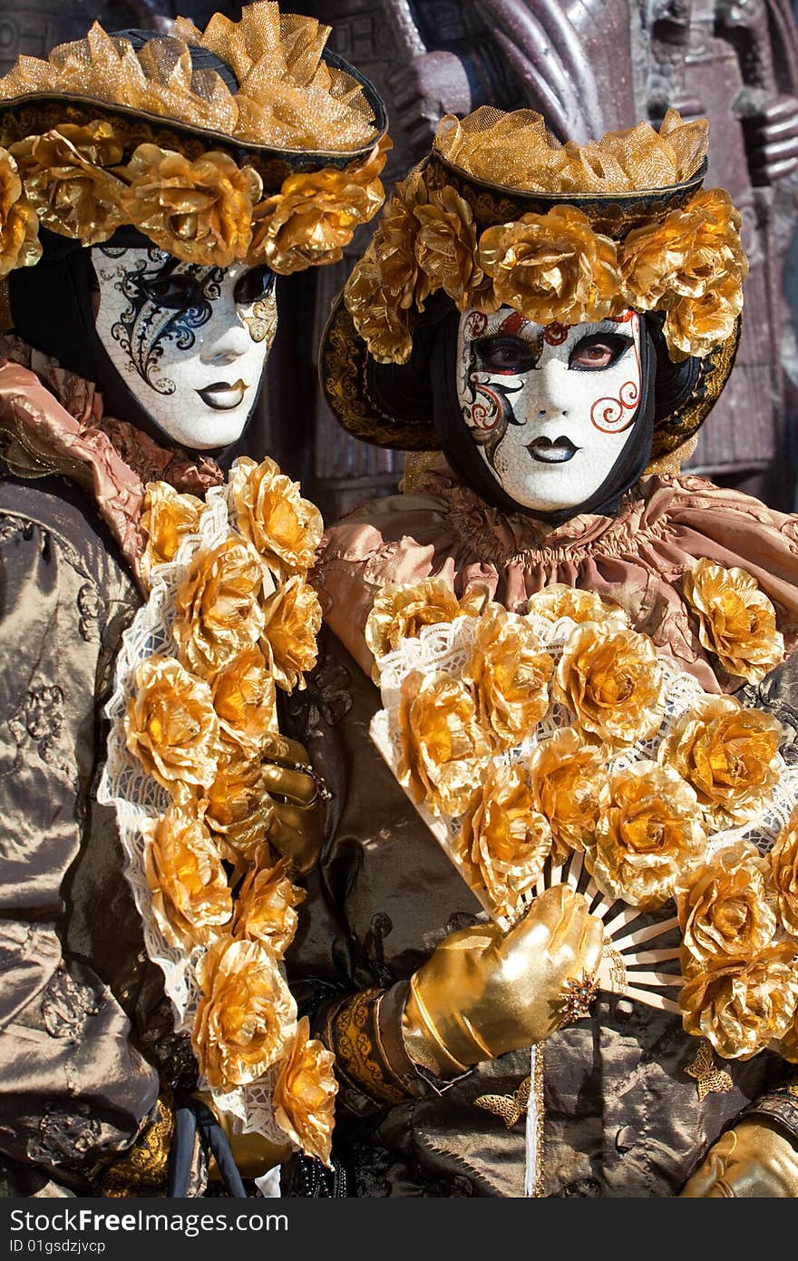 Gold costume with golden roses at the Venice Carnival. Gold costume with golden roses at the Venice Carnival