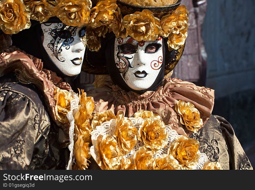 Gold costume with golden roses at the Venice Carnival. Gold costume with golden roses at the Venice Carnival