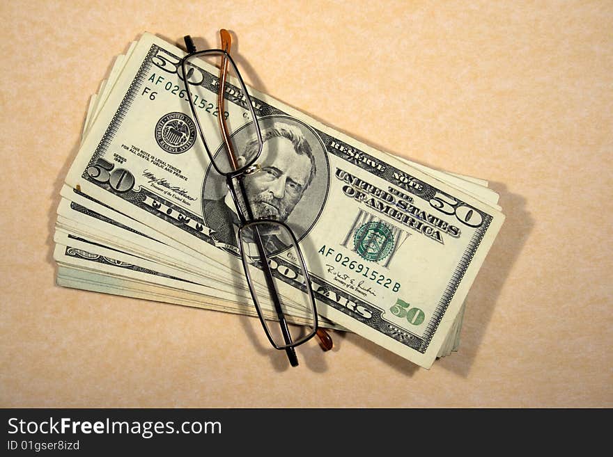 Dollars banknotes and looking glasses. Dollars banknotes and looking glasses