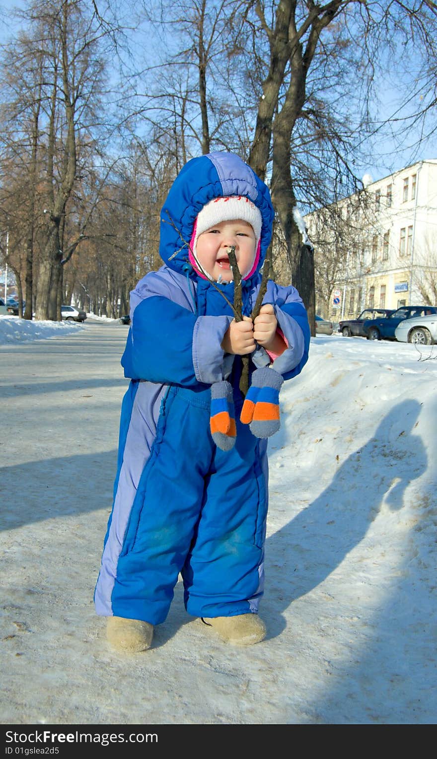 Child playing in the park in winter