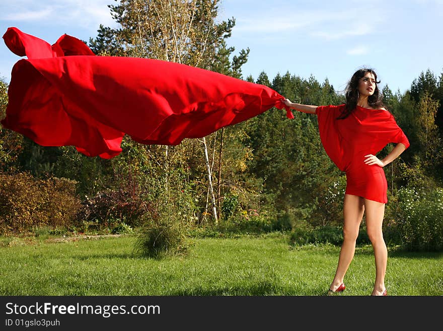 Girl in red dress with flapping fabric. Girl in red dress with flapping fabric